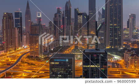 Panorama of Dubai Financial Center district with tall skyscrapers with illumination night to day timelapse. Panorama of Dubai Financial Center district with tall skyscrapers with illumination night to day timelapse. 96800599