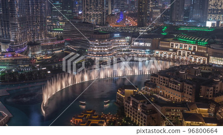 Dubai Fountain aerial night timelapse. Musical fountain, located in an artificial lake in downtown Dubai Fountain aerial night timelapse. Musical fountain, located in an artificial lake in downtown 96800664
