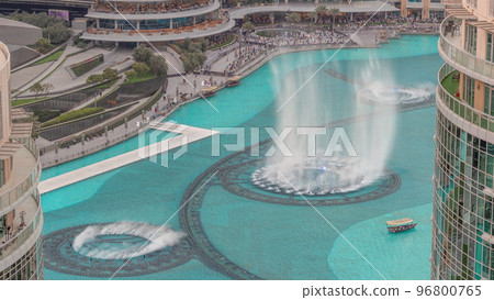 Dubai singing fountains with walking area around aerial view timelapse. Dubai singing fountains with walking area around aerial view timelapse. 96800765