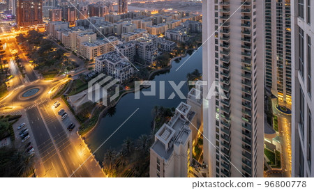 Pond and low rise buildings in Greens district aerial night to day timelapse. 96800778