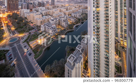 Pond and low rise buildings in Greens district aerial day to night timelapse. Pond and low rise buildings in Greens district aerial day to night timelapse. 96800779