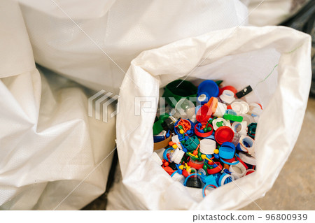 Close-up top view of bag with various plastic waste sorting for further disposal at private waste recycling plant. Concept of waste separation and sustainable lifestyle. Close-up top view of bag with various plastic waste sorting for further disposal at private waste recycling plant. Concept of waste separation and sustainable lifestyle. 96800939