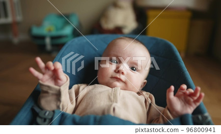 newborn baby in a rocking chair. happy family kid dream concept. portrait newborn baby boy child lifestyle. son boy baby lies in a rocking chair at home in a room indoors newborn baby in a rocking chair. happy family kid dream concept. portrait newborn baby boy child lifestyle. son boy baby lies in a rocking chair at home in a room indoors 96800941