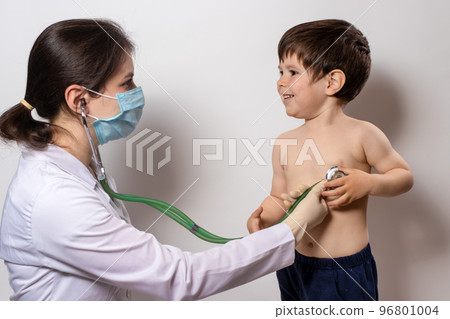 Pediatric examination of a child with a stethoscope. Little boy and pediatrician. Pediatric examination of a child with a stethoscope. Little boy and pediatrician. 96801004