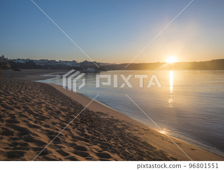 Orange sunrise at empty sand beach Praia da Franquia at Vila Nova de Milfontes with Mira river and fort Forte de Milfonte. Portugal, Rota Vicentina coast Orange sunrise at empty sand beach Praia da Franquia at Vila Nova de Milfontes with Mira river and fort Forte de Milfonte. Portugal, Rota Vicentina coast 96801551