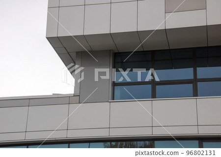 Corner of modern building against gray sky Corner of modern building against gray sky 96802131