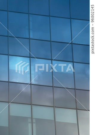 Reflection of clouds in mirrored windows of building Reflection of clouds in mirrored windows of building 96802145