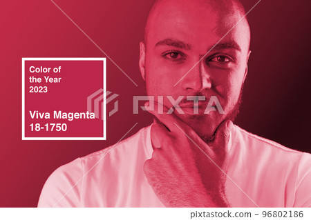 Serious thoughtful guy portrait in magenta light. Color of the year 2023, viva magenta. Serious thoughtful guy portrait in magenta light. Color of the year 2023, viva magenta. 96802186