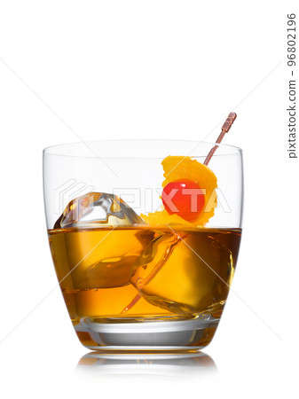 Glass with ice cubes and old fashioned cocktail with cherry and orange peel on white background. Glass with ice cubes and old fashioned cocktail with cherry and orange peel on white background. 96802196