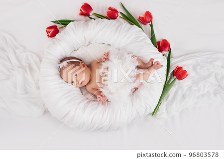 sweet newborn baby in dress with feathers sweet newborn baby in dress with feathers 96803578