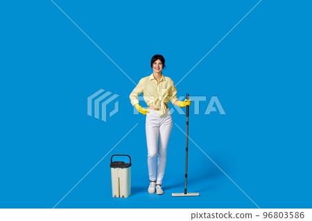 woman in rubber gloves with cleaning supplies 96803586