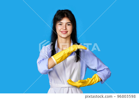 woman gloves and cleaner apron showing measure symbol gesture woman gloves and cleaner apron showing measure symbol gesture 96803598