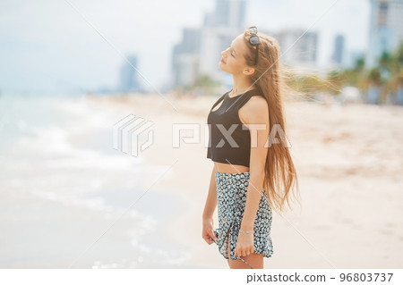 Happy young girl enjoy tropical beach vacation Happy young girl enjoy tropical beach vacation 96803737
