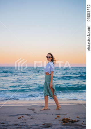 Woman on the beach enjoying summer holidays Woman on the beach enjoying summer holidays 96803752
