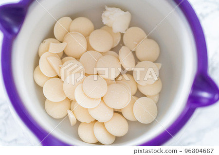 Melting white chocolates to make white chocolate stars. 96804687