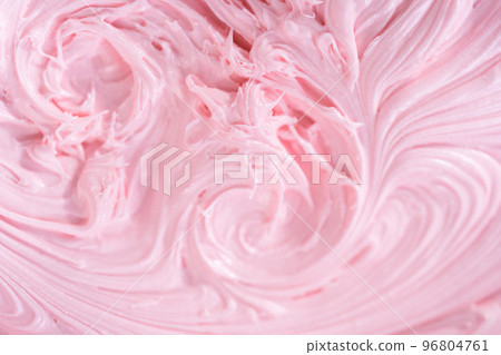 Close up view. Mixing in pink food coloring into a vanilla buttercream frosting for decorating funfettti bundt cake. 96804761