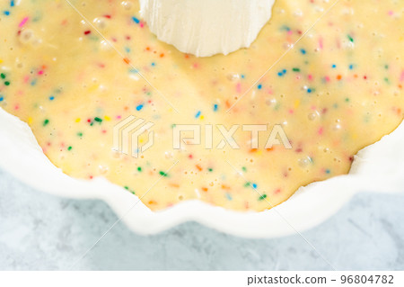 Close up view. Cake batter in a bundt cake pan to bake funfettti bundt cake. 96804782