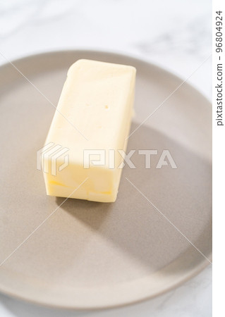 Sticks of unsalted butter on the small plates. Sticks of unsalted butter on the small plates. 96804924