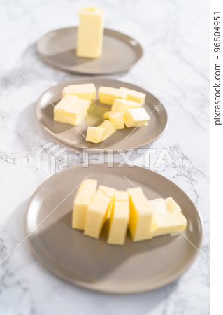 Softened sticks of unsalted butter on the counter. Softened sticks of unsalted butter on the counter. 96804951