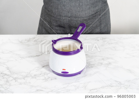 Melting stick of unsalted butter in candy melting pot. Melting stick of unsalted butter in candy melting pot. 96805003