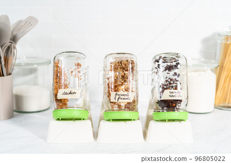 Day 2. Growing organic sprouts in a mason jar with sprouting lid on the kitchen counter. 96805022