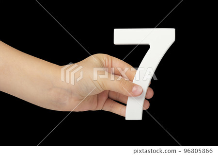 Number seven in hand isolated on black background. Number 7 in a child's hand on a black background. To be inserted into a project or design. Number seven in hand isolated on black background. Number 7 in a child's hand on a black background. To be inserted into a project or design. 96805866