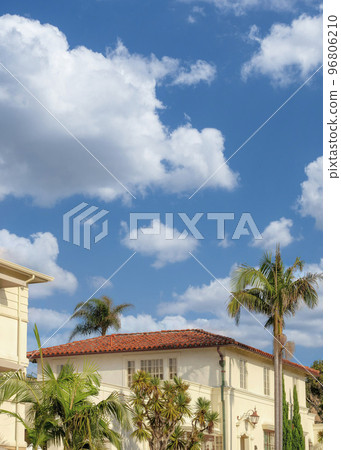 Vertical White puffy clouds Side view of a residential buildings with trees outside at La Jo 96806210