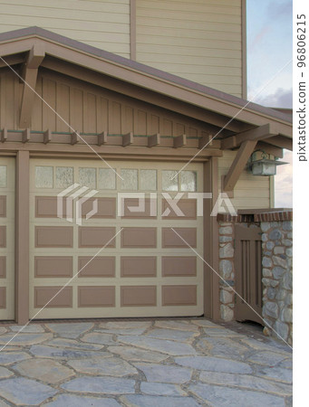 Vertical Puffy clouds at sunset Attached garage exterior with vinyl lap and stone veneer sidings Vertical Puffy clouds at sunset Attached garage exterior with vinyl lap and stone veneer sidings 96806215