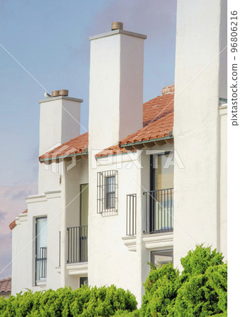 Vertical Puffy clouds at sunset White residential building at La Jolla, California 96806216