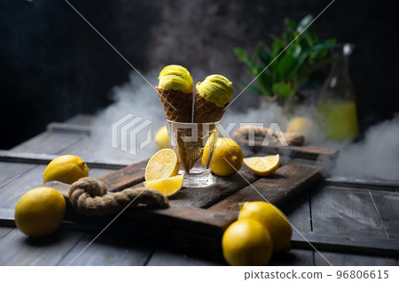 fresh lemon citrus sorbet or ice cream with chopped fresh fruit on the wooden table on the background fresh lemon juice and vase with flowers in a fume. still life ice cream, juice, wood, fume fresh lemon citrus sorbet or ice cream with chopped fresh fruit on the wooden table on the background fresh lemon juice and vase with flowers in a fume. still life ice cream, juice, wood, fume 96806615