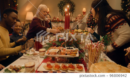 Happy diverse family serving Christmas table 96806942