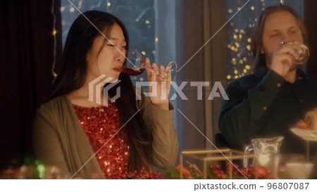 Friends clink glasses celebrating Christmas 96807087