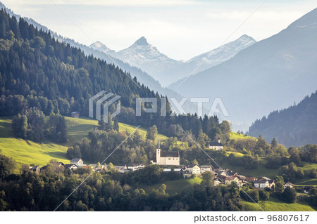 Idyllic landscape of village in Engadine valley, Swiss Alps, Switzerland Idyllic landscape of village in Engadine valley, Swiss Alps, Switzerland 96807617