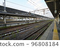 Railway station with multiple platforms under elevated Shinkansen 96808184