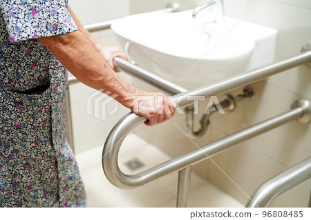 Asian elderly old woman patient use toilet support rail in bathroom, handrail safety grab bar, security in nursing hospital. Asian elderly old woman patient use toilet support rail in bathroom, handrail safety grab bar, security in nursing hospital. 96808485