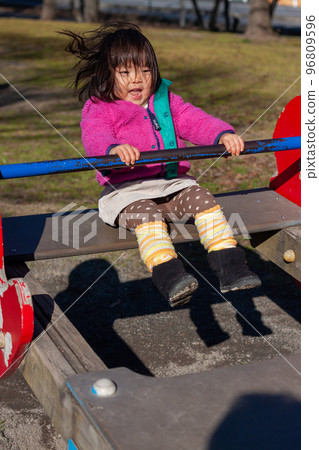 Girls playing in the park 96809596
