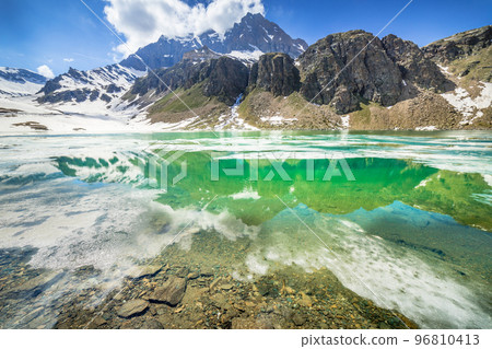 Alpine emerald lake and mountains at springtime, Gran Paradiso Alps, Italy Alpine emerald lake and mountains at springtime, Gran Paradiso Alps, Italy 96810413
