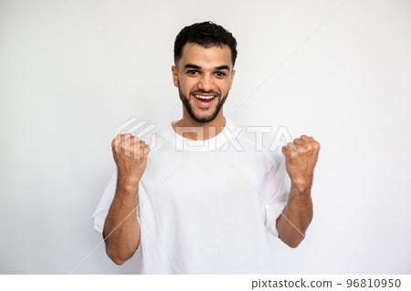 Portrait of happy young man making winning gesture 96810950