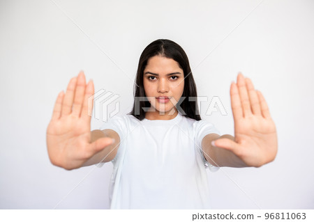 Portrait of serious young woman making denial gesture 96811063