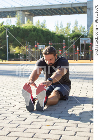 Portrait of serious man with leg prothesis exercising outdoors 96811070