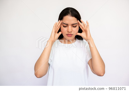 Portrait of stressed young woman suffering from headache 96811071