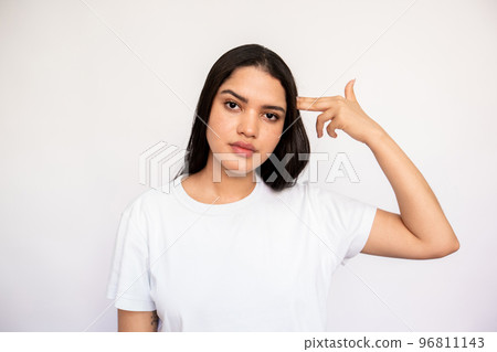 Portrait of stressed young woman making suicide gesture Portrait of stressed young woman making suicide gesture 96811143