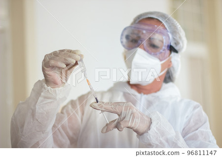 Close-up of female doctor working with vaccine for coronavirus 96811147