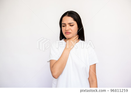 Portrait of displeased young woman touching her throat Portrait of displeased young woman touching her throat 96811259