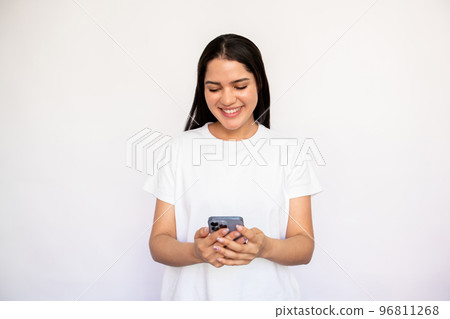 Portrait of happy young woman texting or reading message Portrait of happy young woman texting or reading message 96811268