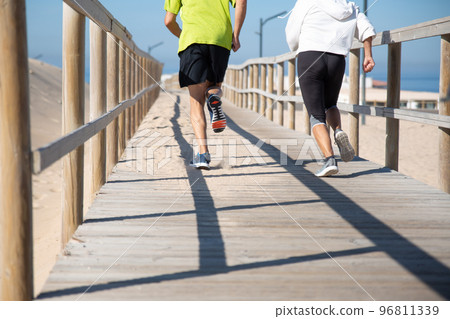 Back view of elderly couple running away 96811339