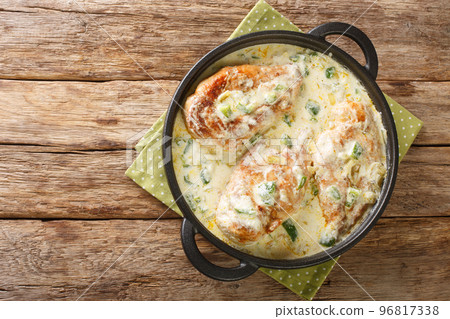 Tasty Mexican Pollo Con Crema Chicken in a creamy sauce with green peppers, onion and garlic closeup in the pan. Horizontal top view 96817338