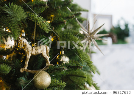 Christmas toy horse and balls hang on the tree, decorated with lights. Copy space Christmas toy horse and balls hang on the tree, decorated with lights. Copy space 96817653