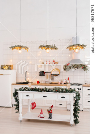Winter cozy kitchen with red decorations, christmas kitchen table and utensils Winter cozy kitchen with red decorations, christmas kitchen table and utensils 96817671
