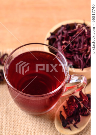 Roselle tea in cup glass with dry roselle on wooden background, Herbal drink Roselle tea in cup glass with dry roselle on wooden background, Herbal drink 96817740
